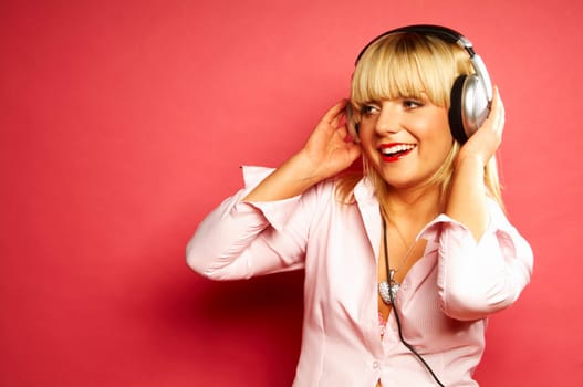 Young beautiful happy women listening music in headphones