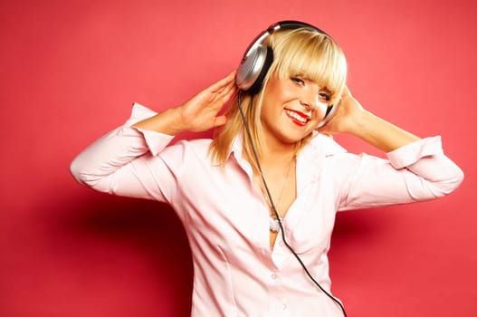 Young beautiful happy women listening music in headphones