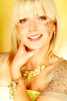 Portrait of beautiful young smiling woman with red lipstick and golden stars on chick