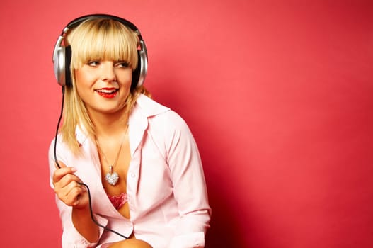 Young beautiful happy women listening music in headphones