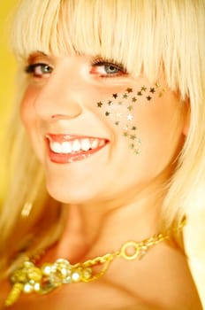 Portrait of beautiful young smiling woman with red lipstick and golden stars on chick