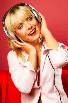Young beautiful happy women listening music in headphones