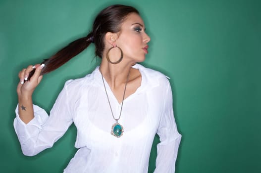 Portrait of Young woman isolated on green background