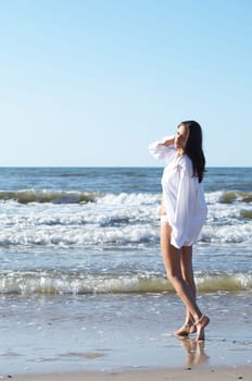 20-25 years old Beautiful Woman on the beach, wearing shirt