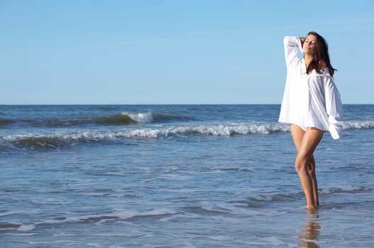 20-25 years old Beautiful Woman on the beach, wearing shirt