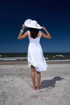 20-25 years old Beautiful Woman on the beach, wearing hat