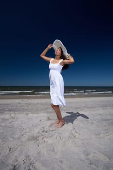 20-25 years old Beautiful Woman on the beach, wearing hat