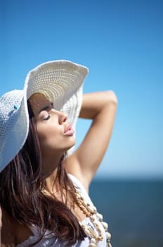20-25 years old Beautiful Woman on the beach, wearing hat
