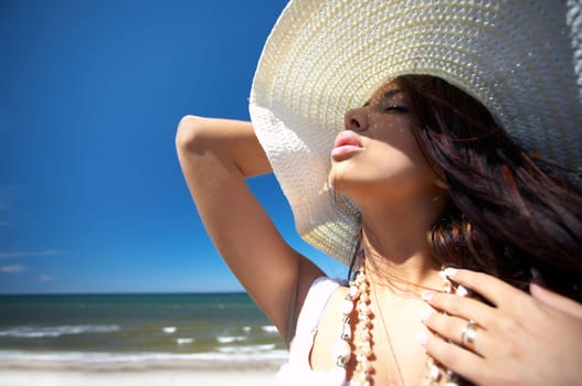 20-25 years old Beautiful Woman on the beach, wearing hat