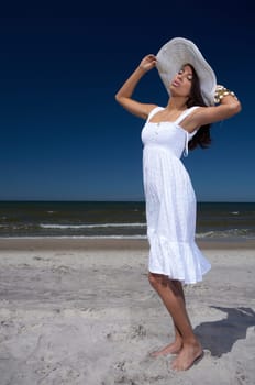 20-25 years old Beautiful Woman on the beach, wearing hat