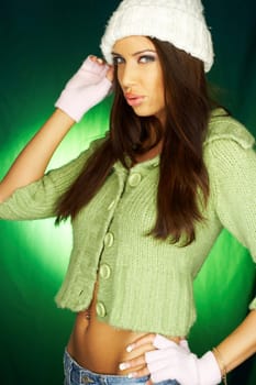 Portrait of beautiful woman wearing green sweater an white hat
