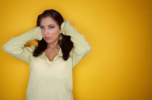 Portrait of Young woman isolated on yellow background