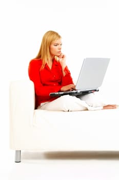 Young pretty women on couch relaxing and using laptop computer