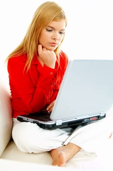 Young pretty women on couch relaxing and using laptop computer