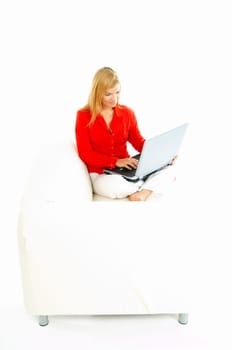 Young pretty women on couch relaxing and using laptop computer