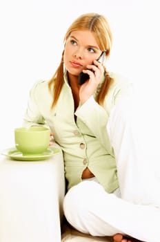 Portrait of attractive beautiful young woman with green cup of black coffee and cell phone