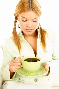 Portrait of attractive beautiful young woman with green cup od black coffee