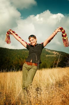 Young business woman relaxing on mountain meadow