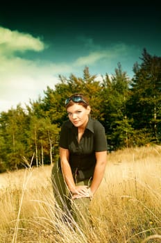 Young business woman relaxing on mountain meadow