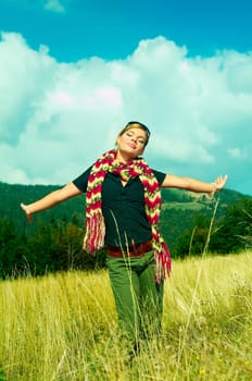 Young business woman relaxing on mountain meadow