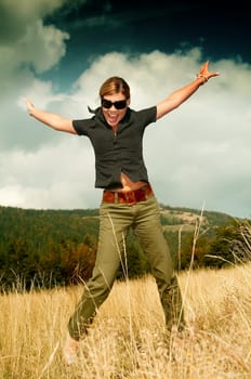 Young business woman relaxing on mountain meadow