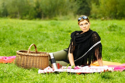 Young business woman during picnic on green meadows outdoors