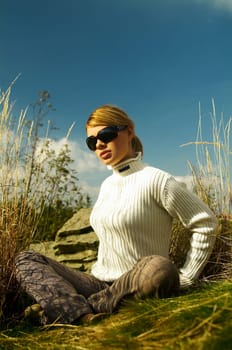 Young beautiful model posing in mountain outdoor scenery