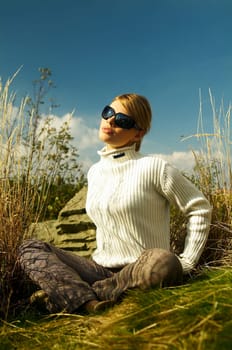 Young beautiful model posing in mountain outdoor scenery