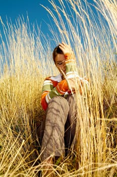 Young business woman relaxing on golden meadow