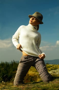 Young beautiful model posing in mountain outdoor scenery