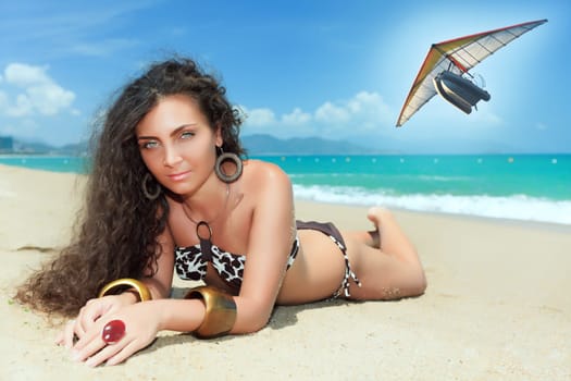 Sunbathing woman. Flying boat on the bbackground