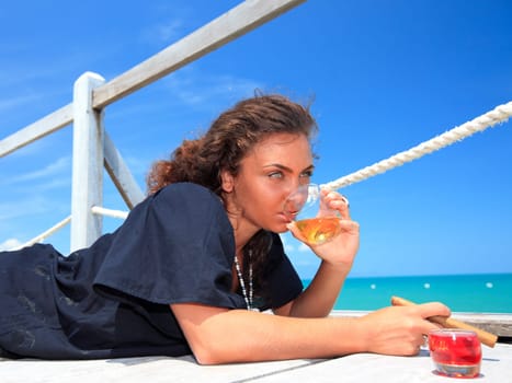 Young woman with cigar and a glass of whiskey