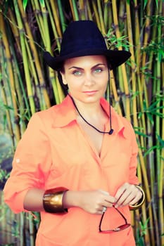 Fashion style portrait of woman at tropical garden