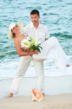 man carrying woman on the tropical beach
