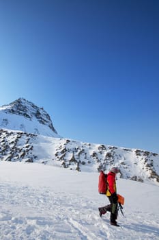 A female mountaineer against a mountain landscape, Svalbard, Norway