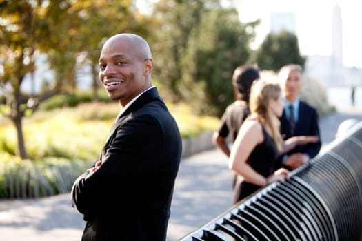 A group of business colleagues in the park - focus on front man