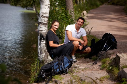 A couple taking a break while on a hiking camping trip