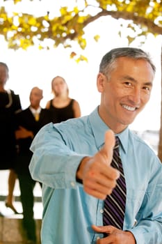 A casual business man with thumbs up
