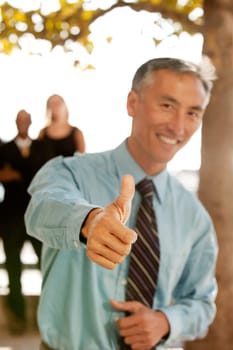 A casual business man with thumbs up