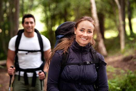 A pretty female on a camping trip with a male in the background
