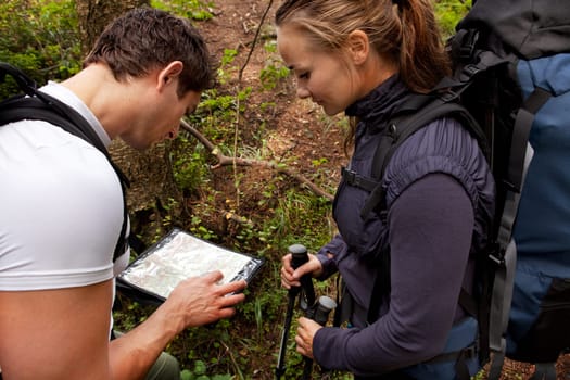 A coupld with map and compass in the forest - lost