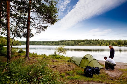 A couple camping on a lake landscape