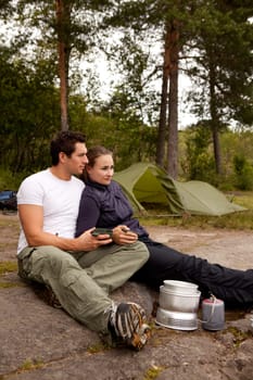 A couple cooking and ejoying the outdoors