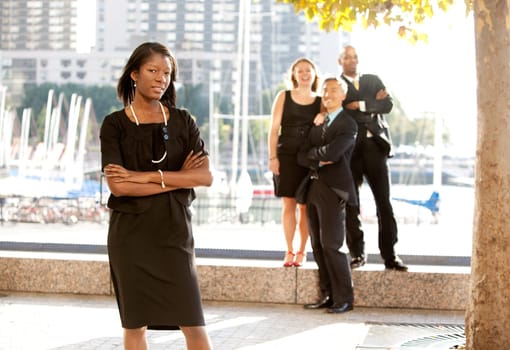 An African American woman in front of a business team
