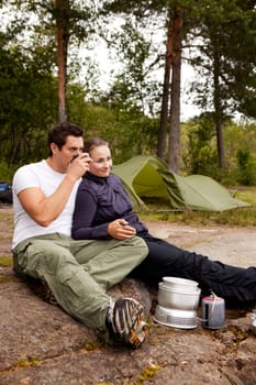 A couple cooking and ejoying the outdoors