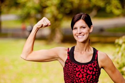 A pretty fitness model flexing her bicep