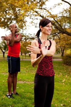 A group of people stretching in the park