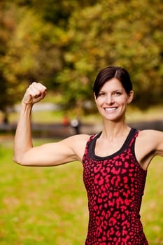 A female fitness model flexing her bicep