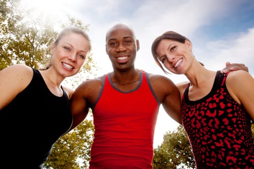 A group of friends exercising in the park on a warm sunny day