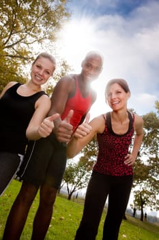 A happy group of people in the park exercising